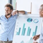 multiethnic businessmen standing near white board 74gv65m