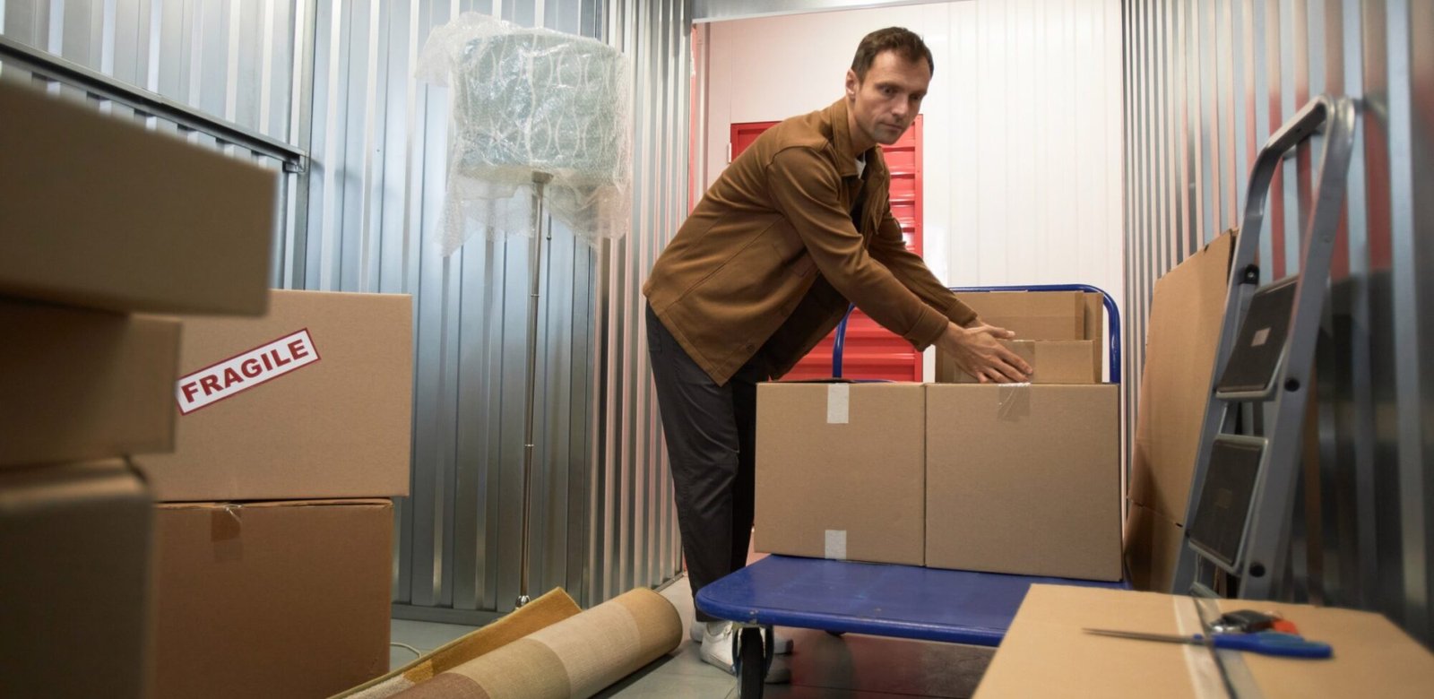 man sorting boxes in storage unit 9a5ulyc